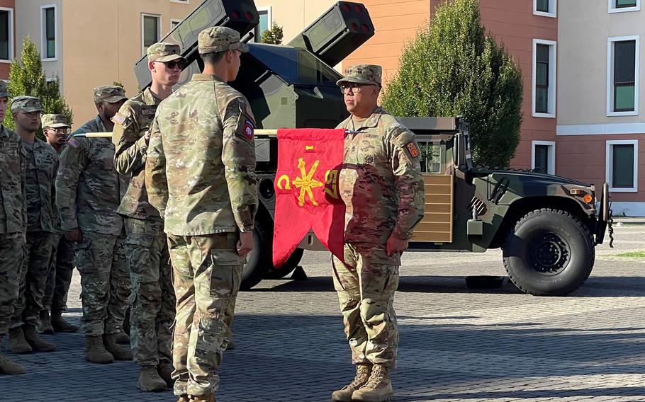 Battery commander Capt. Evan Bicoy and 1st Sgt. Allanmarco Cruz uncase the guidon at a ceremony Oct. 17, 2023, in Vicenza, Italy, marking the reactivation of Charlie Battery, 1st Battalion, 57th Air Defense Artillery Regiment. The unit became the newest Army short-range air defense battery in Europe. 