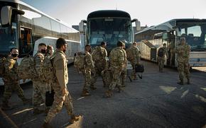 U.S. soldiers assigned to the 1st Infantry Division get on a bus after arriving in Poland, Feb. 28, 2022. Since Russia's invasion of Ukraine in February, the U.S. has sent an additional 20,000 troops to Europe, putting the overall American force number on the Continent at just over 100,000. 