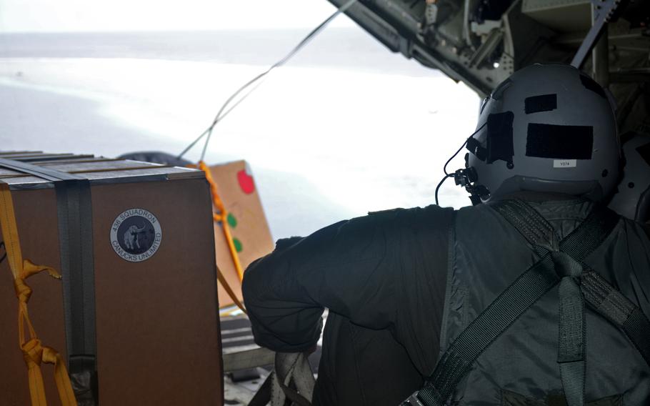 A crate filled with donated Operation Christmas Drop supplies begins its descent toward the Eauripik islands in the Federated States of Micronesia, Wednesday, Dec. 7, 2022. 