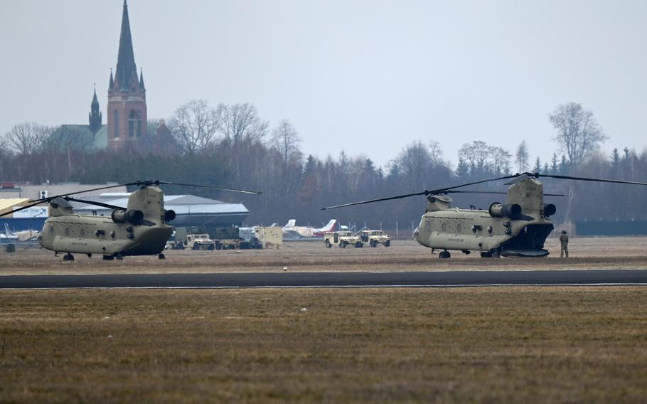 Two U.S. Army CH-47 Chinook helicopters sit on an airfield on the outskirts of Mielec, Poland, Feb. 26, 2022.