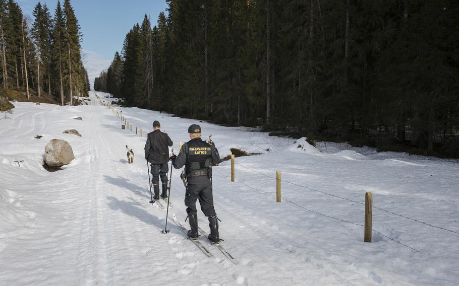 Finnish border guards and their German shepherd patrol the Finland-Russia border on April 22. 