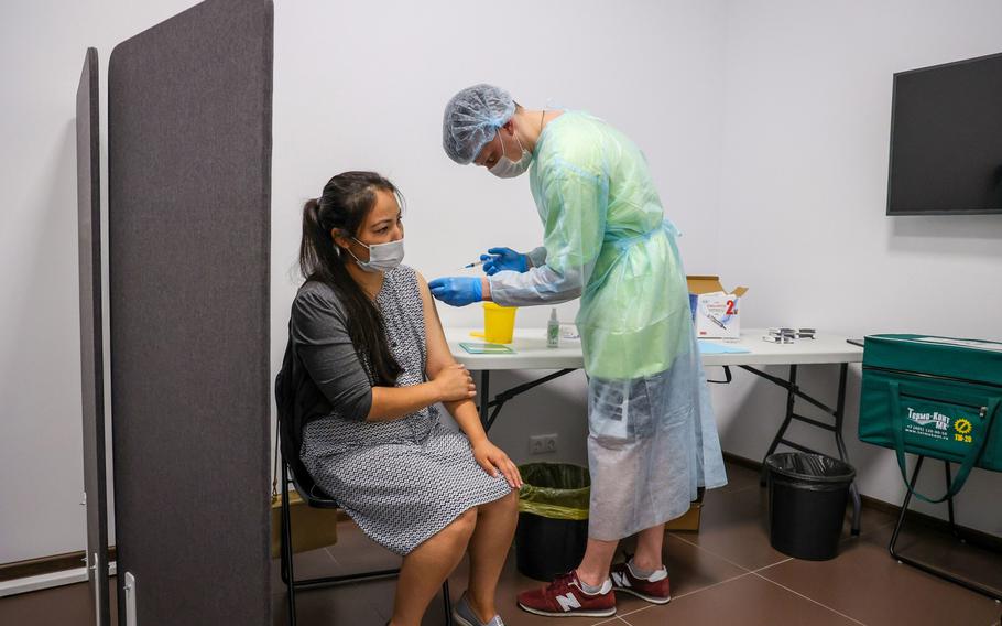 A worker receives a dose of the Sputnik V COVID-19 vaccine at a Yandex office in Moscow on June 28, 2021. 