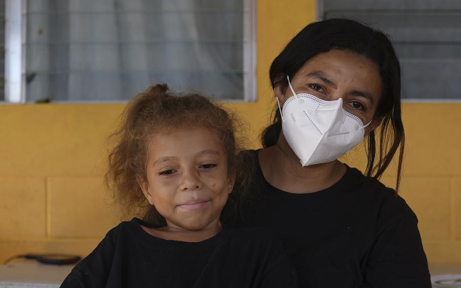 Asylum-seeker from Honduras, Carla Leiva, 32, holds her five-year-old daughter Zoe as they pose for a photo at the "Casa del Migrante" shelter for migrants in El Ceibo, Guatemala, Thursday, Aug. 12, 2021.