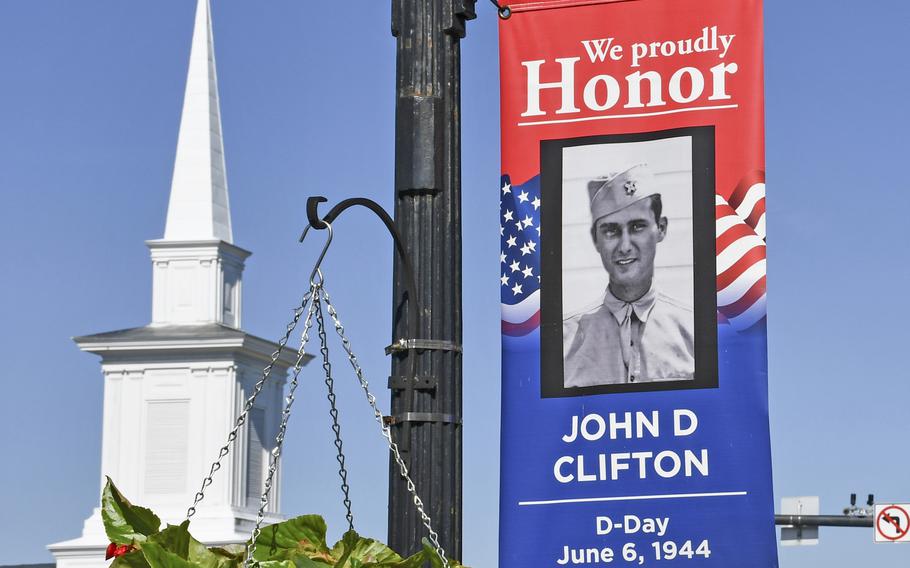 Flags lining the downtown thoroughfare in Bedford, Va., on May 14, 2019, show photos of 19 soldiers from Bedford who were killed in action on D-Day. The town is home to the National D-Day Memorial.