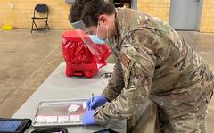 A Minnesota National Guard logistics solider conducts a COVID-19 nasal swab testing support at a Community Based Testing Site at the Hibbing, Minnesota Armory on December 20, 2021.  The Minnesota National Guard is partnering with the Minnesota Department of Health to staff six community based COVID-19 testing sites across Minnesota.  (U.S. Air National Guard photo by Audra Flanagan)