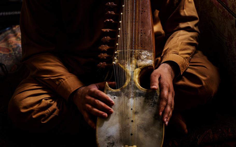 A man holds an Afghan rubab in his workshop, in Kabul, Afghanistan, Sunday, May 2, 2021. With U.S. and NATO forces planning to depart the country in as little as a few weeks, they leave behind an Afghan state that few believe can withstand a Taliban onslaught. 