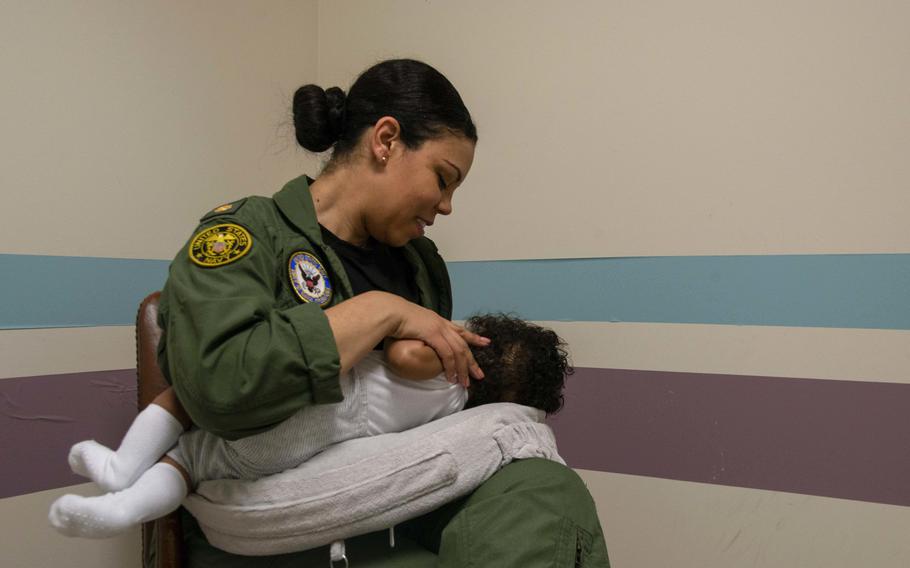 A sailor feeds her child in the lactation room at Naval Support Facility Arlington, Va., June 6, 2019. Nursing mothers on military assignment may now be reimbursed up to $1,000 to ship breast milk when on official travel for more than three days, under a revised Pentagon policy adopted earlier this month.
