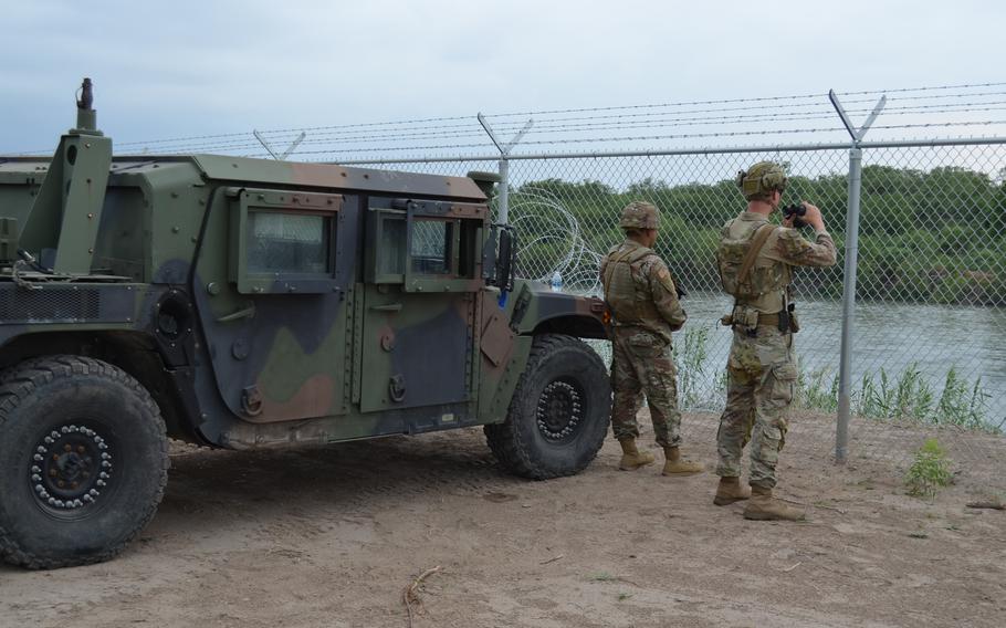 Texas National Guard troops watch over the Rio Grande in Eagle Pass, Texas, in May 2022 as part of the state-sponsored border security mission known as Operation Lone Star. 