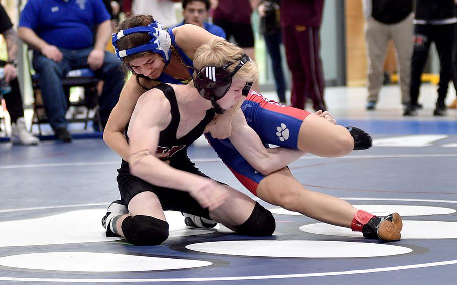 Vilseck's Christopher Wissemann and Ramstein's Liberty Snyder grapple during a 113-pound semifinal match at Ramstein High School on Saturday on Ramstein Air Base, Germany.