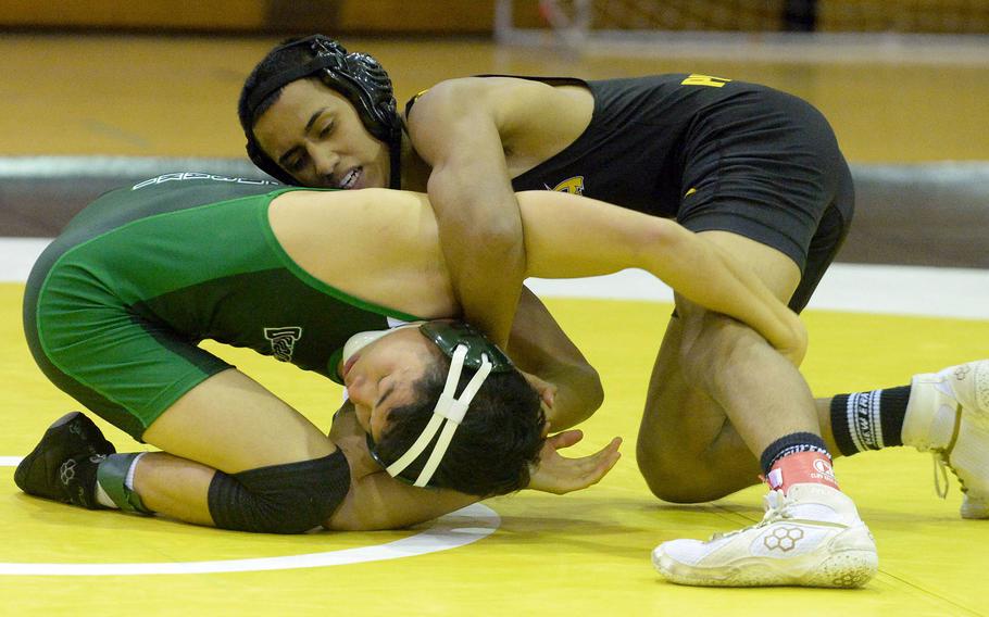 Kadena 121-pounder Jesse Vences gains the edge on Kubasaki's Gavin Ocampo during Wednesday's Okinawa wrestling regular-season finale. Vences won by pin in 3 minutes, 24 seconds, and the Panthers won the meet 34-28, completing a six-match regular-season sweep of the Dragons.