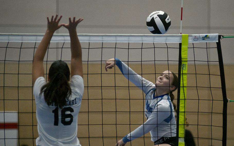 Wiesbaden's Rylee Ashcraft hits the ball at the net while Stuttgart's Sara Houghton tries to block during pool-play action of the DODEA European volleyball championships on Oct. 26, 2023, at Ramstein High School on Ramstein Air Base, Germany.