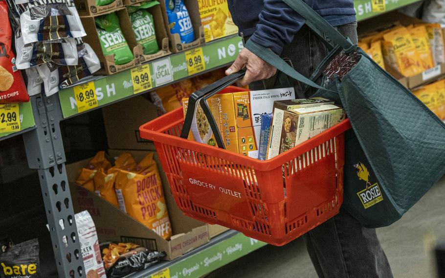 A shopper holds a shopping basket with groceries inside a grocery store in San Francisco, Calif., U.S., on Monday, May 2, 2022. U.S. inflation-adjusted consumer spending rose in March despite intense price pressures, indicating households still have solid appetites and wherewithal for shopping.