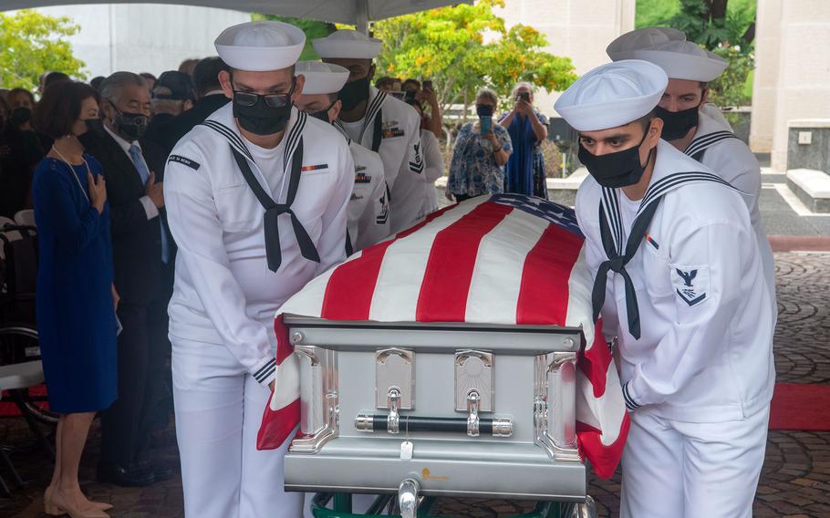 Sailors assigned to Navy Region Hawaii and the Defense POW/MIA Accounting Agency carry a casket during a USS Oklahoma re-interment ceremony at the National Memorial Cemetery of the Pacific in Honolulu, Hawaii, Dec. 7, 2021. 