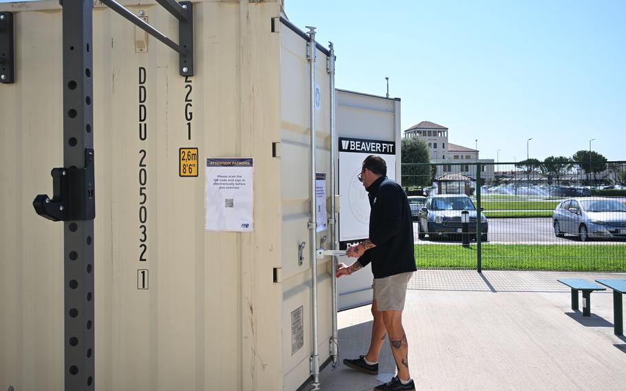 A man closes a large metal container.