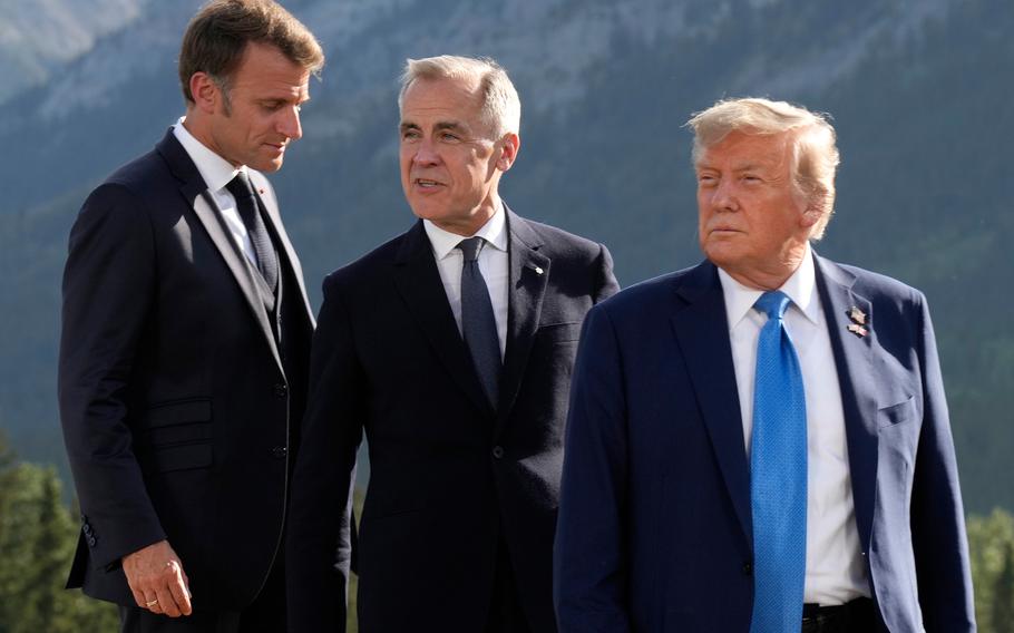 French President Emmanuel Macron, Canadian Prime Minister Mark Carney and President Donald Trump take a photo for the G7 Summit. 