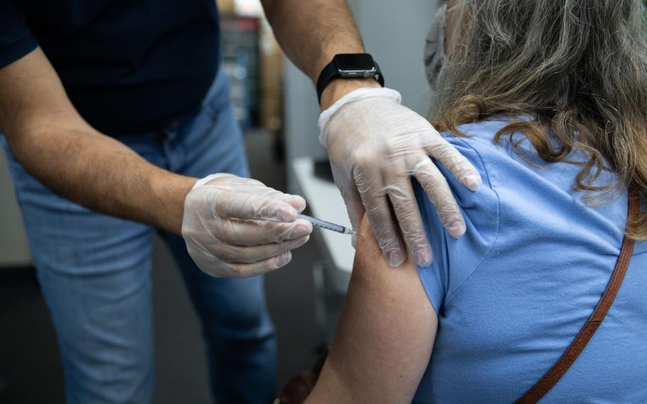 A pharmacist administers a third dose of the Pfizer-BioNTech covid-19 vaccine to a customer at a pharmacy in Livonia, Michigan, on Aug. 17, 2021. 