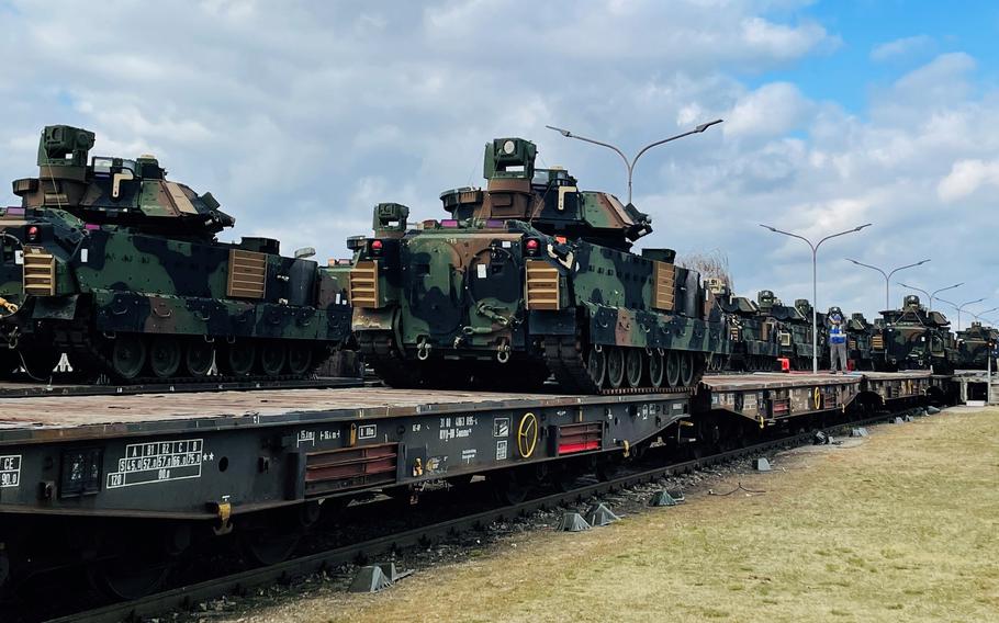 Dozens of Bradley Fighting Vehicles are loaded onto German rail cars in Mannheim, Germany, March 14, 2022.