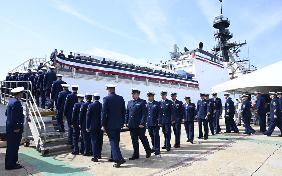The crew of the Coast Guard Cutter Calhoun (WMSL 759) boards the ship following its commissioning ceremony in North Charleston, S.C., Saturday, April 20, 2024. The Calhoun is named for the first master chief petty officer of the Coast Guard, Charles Calhoun.