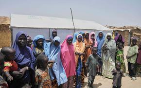 FILE - Women and children displaced by Boko Haram attacks are seen outside their camp in Dikwa, northeast Nigeria, on April 29, 2025. (AP Photo/Sunday Alamba, File)
