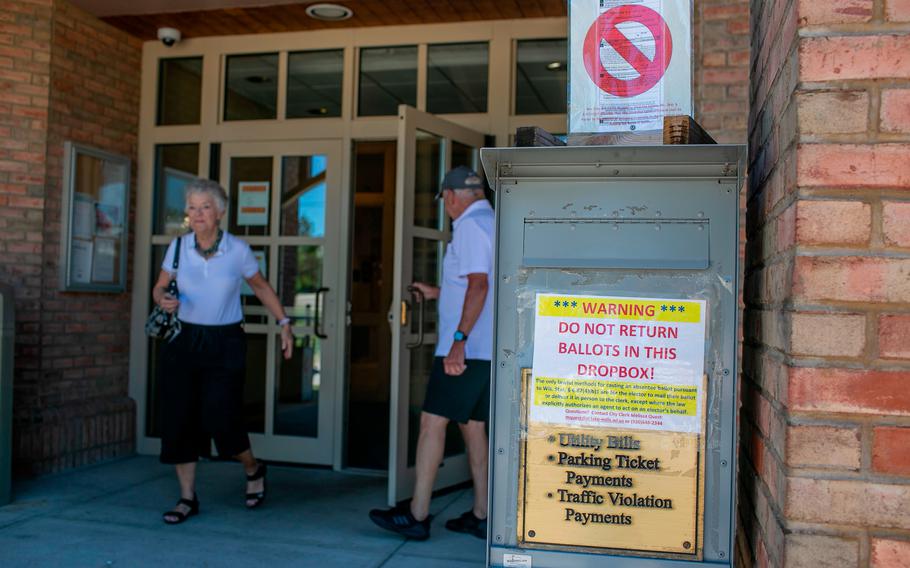 Voters leave Lake Mills Municipal Building after casting ballots in the Wisconsin primary in Lake Mills, just outside Madison, on Aug. 9, 2022.