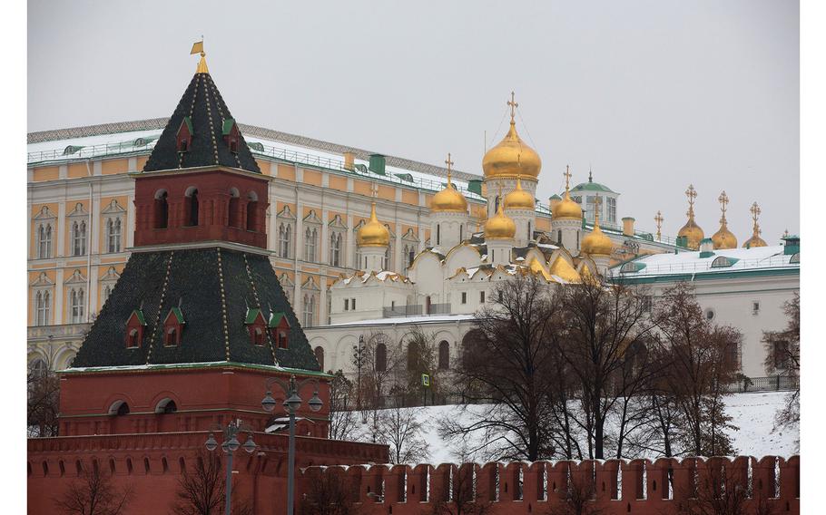 Golden church domes sit beyond fortified walls in the Kremlin palace complex in Moscow in 2016.