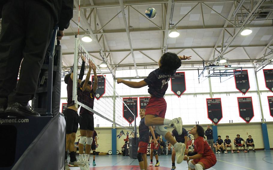 Lakenheath's Rylen Pontemayor jumps and goes for a spike against the Vilseck Falcons' defense on Saturday.