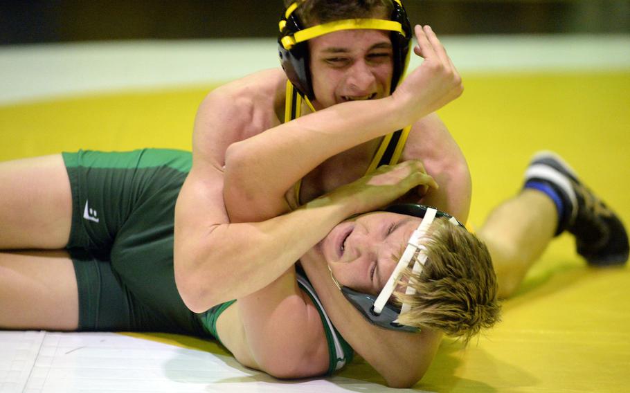 Kubasaki’s Brady Potter tries to fight off Kadena’s Bruce Young at 135 pounds during Wednesday’s Okinawa wrestling dual meet. Young pinned Potter in 2 minutes, 43 seconds, but the Dragons took the meet 40-23.