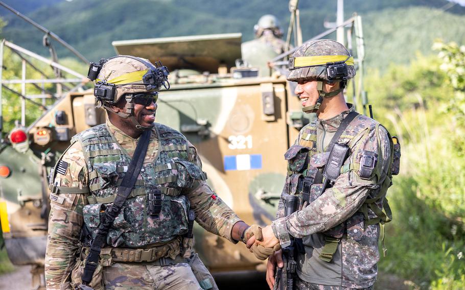A U.S. soldier from the 1st Armored Brigade Combat Team, 1st Armored Division, greets a South Korean soldier during an 11-day exercise at the Korean Combat Training Center in Gangwon Province, South Korea. 