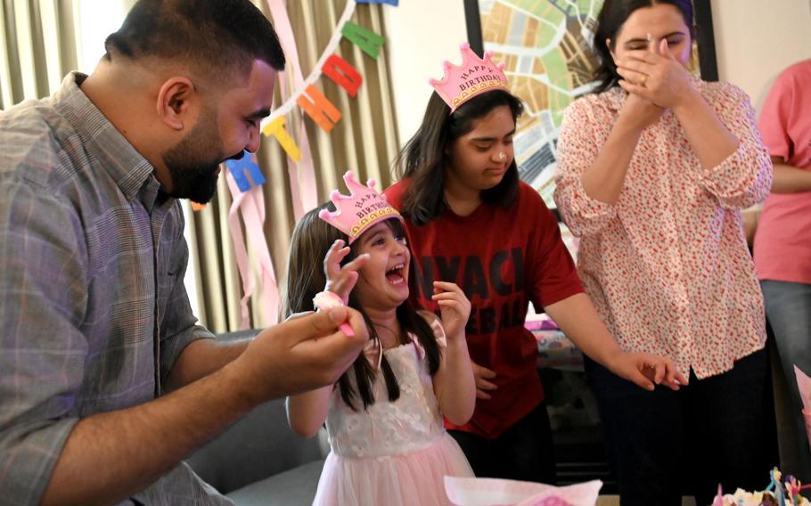 Wali Zadran , left, an Afghan refugee, at a birthday party for his daughter, Hareer, who is turning 4. Wali and his wife Khadija, right, have always had elaborate birthday parties for their only child and wanted to continue that tradition even though they were living in a hotel at the time. Wali’s younger sister, Zala, also enjoys the party.