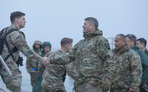 Army Maj. Gen. William Taylor greets soldiers arriving at Osan Air Base, South Korea, Feb. 21, 2024.