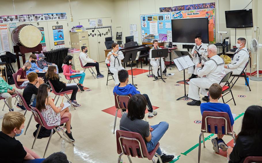 Lanham Elementary School listen to a performance by members of the 7th Fleet Band during a STEAM event at Naval Air Facility Atsugi, Japan, May 27, 2021.