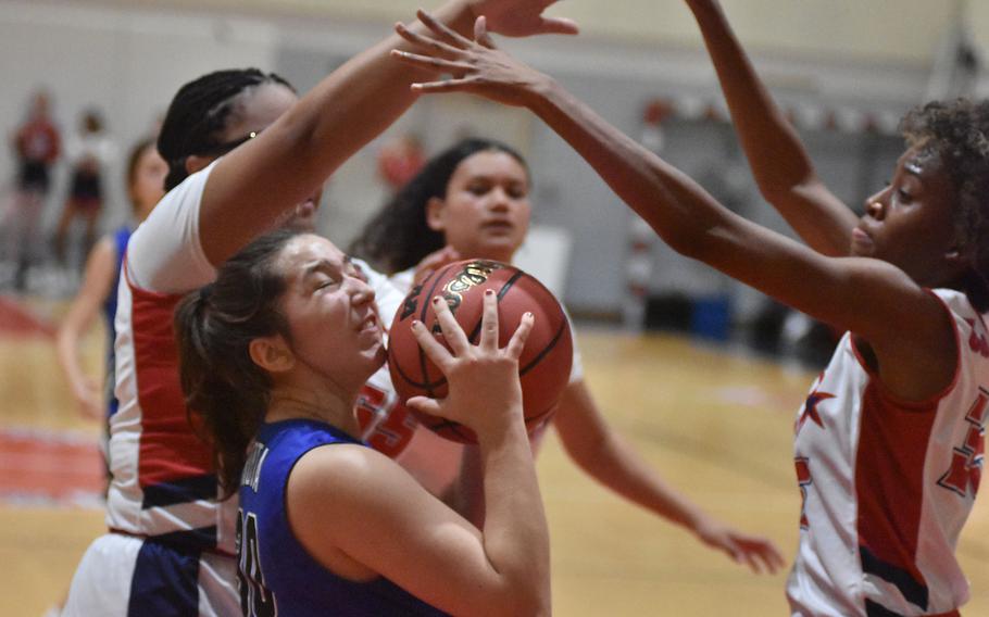 Rota's Maddie Lewis is cut off from the basket by the long arms of Aviano's Alayna Williams, left, and Lania Burkes on Friday, Dec. 9, 2022, in Aviano, Italy.