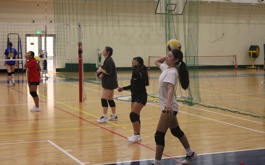 Volleyball players practice.
