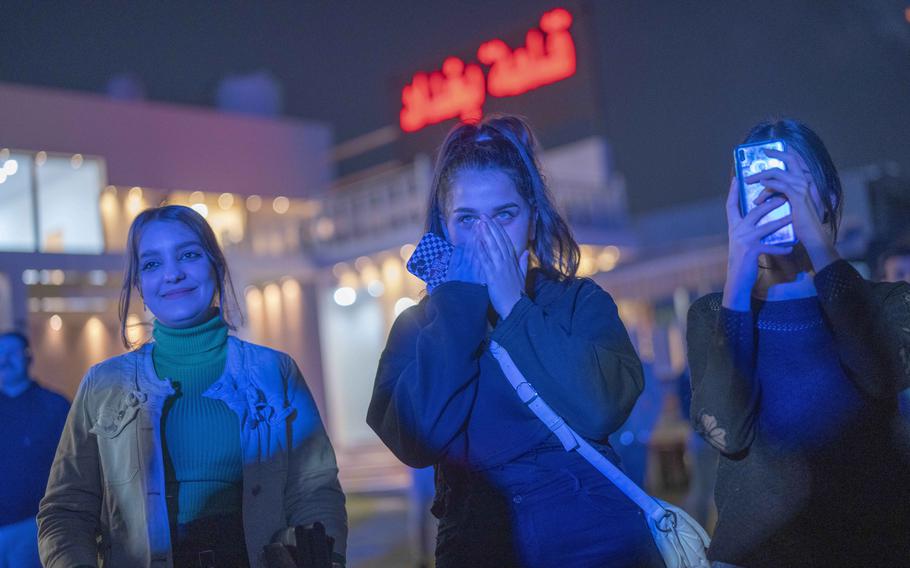 Youths gather along the Tigris River for a concert by rap artist OG Khalifa in Baghdad, Iraq, Saturday Feb. 25, 2023. One of the songs he performs mocks “sheikhs,” those who wield power in the new Iraq through wealth or political connections.