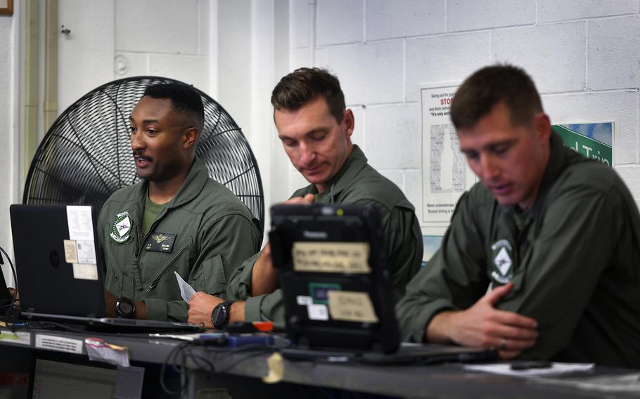 Marine Capt. Zach Mullins, left, completes computer work after a training flight in August at Marine Corps Air Station Miramar in San Diego.