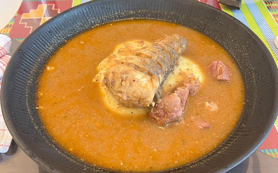 An orange bowl of soup with food in the middle at Quagies in Kaiserslautern, Germany.