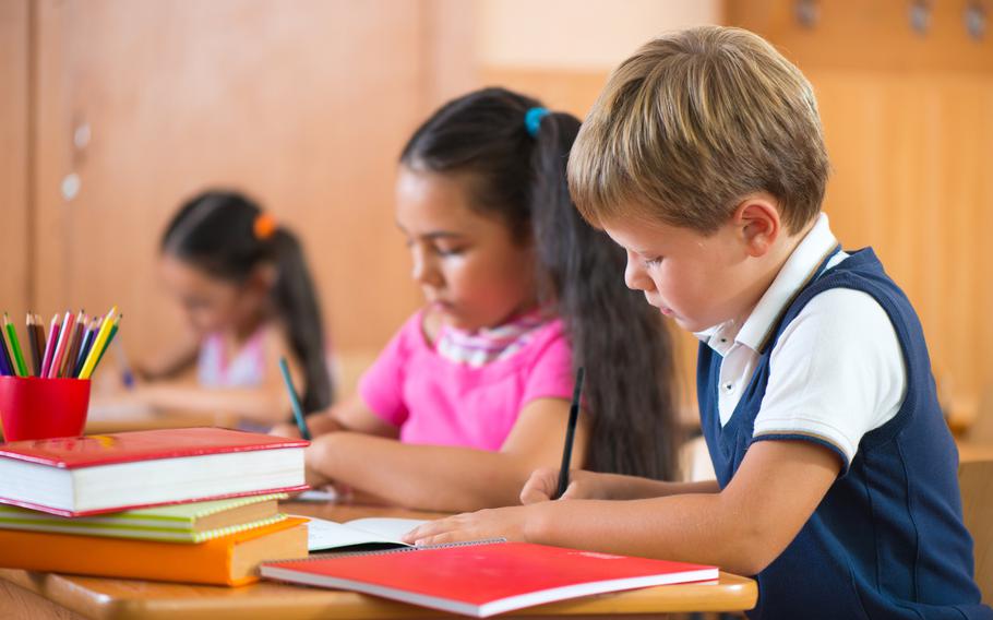 schoolchildren during lesson in classroom at school