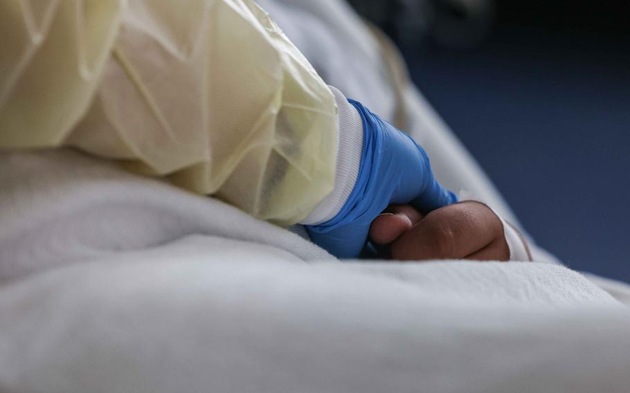 Nurse Christina Walker checks on Francisco Rosales, 9, who is being treated as a COVID-19 patient in the pediatric intensive care unit at the Children’s Medical Center in Dallas on Aug. 13, 2021. 