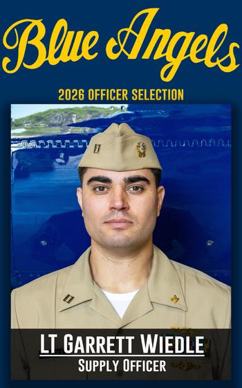 A service member grins for a photo
