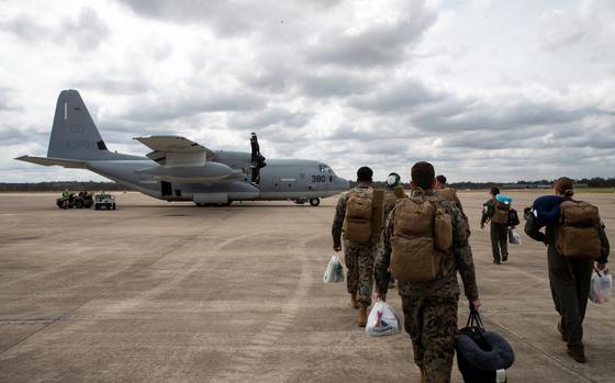 Members of Marine Rotational Force-Darwin prepare to board a KC-130J Super Hercules at Royal Australian Air Force Base Amberley, Australia, Sept. 14, 2022. 