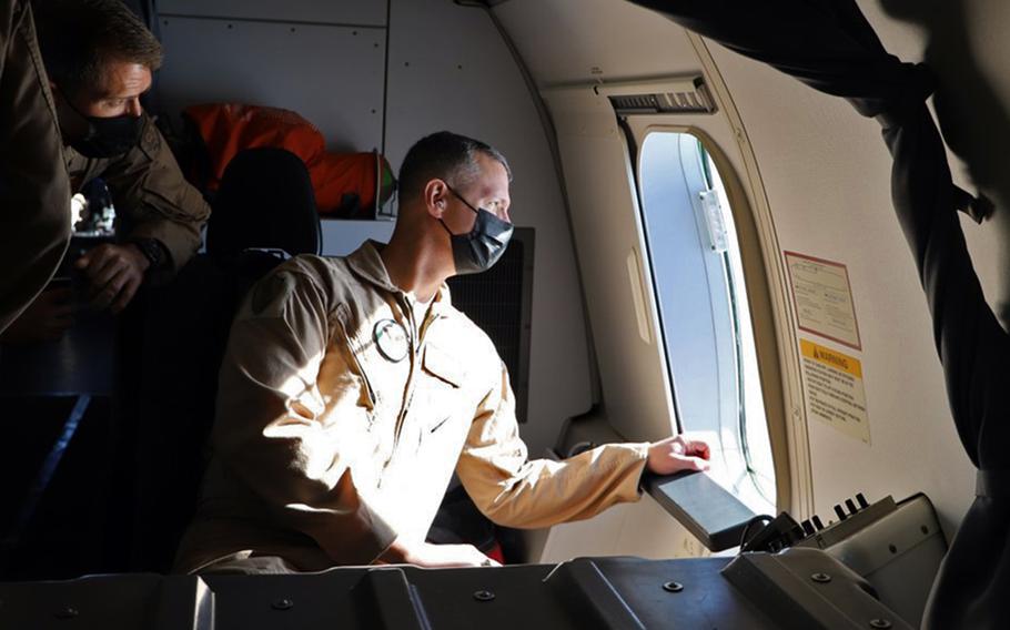 Air Force Maj. Gen. Alexus G. Grynkewich looks out the window of a P-8A Poseidon patrol and reconnaissance aircraft in the 5th Fleet area of operations, Feb. 6, 2022. Grynkewich took command of 9th Air Force (Air Forces Central) at a ceremony at Al Udeid Air Base, Qatar, July 21, 2022.