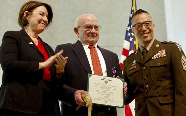 Korean War veteran Earl Meyer receives the Purple Heart medal from Command Sgt Maj. Jason Rost of the Minnesota National Guard and U.S. Sen. Amy Klobuchar, D-Minn., during a ceremony on May 17, 2024, in St. Peter, Minn.
