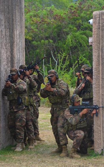 Members of His Majesty’s Armed Forces Royal Tongan Marines prepare to assault a complex in a faux village at Bellows Air Force Base, Hawaii, July 18, 2022, as part of the Rim of the Pacific exercise.
