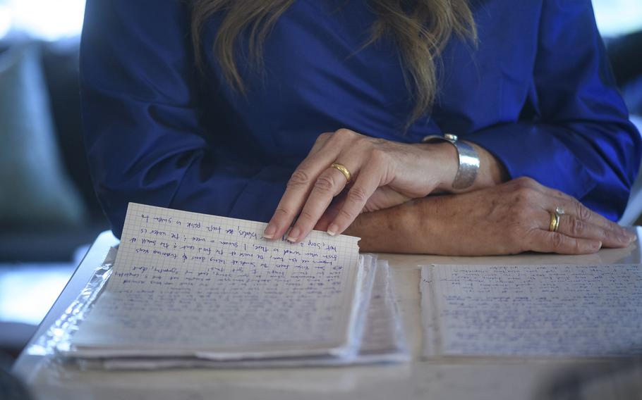 At home in Oakmont, Pa., Jane Fogel now wears her wedding ring with husband Marc’s wedding ring, as she reads the letters she has received from him since his imprisonment in Russia.