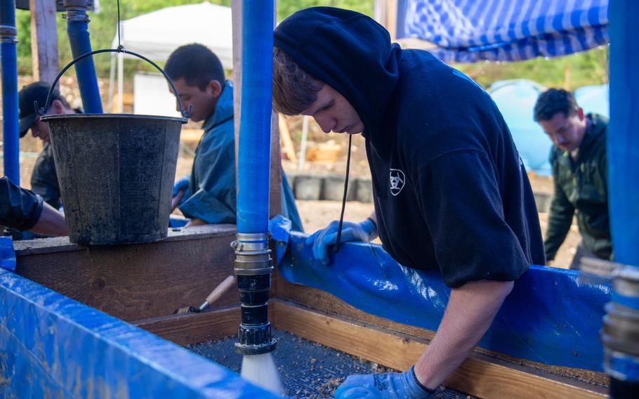 Army Pfc. Michael Cannan, assisting the Defense POW/MIA Accounting Agency, screens soil during a recovery mission in Italy, May 21, 2024. 