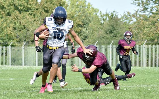 Ansbach running back Daeveon Browne stiff-arms his way past Buccaneer Keryel Badillo during a Sept. 16, 2023, game at Baumholder Middle High School in Baumholder, Germany.