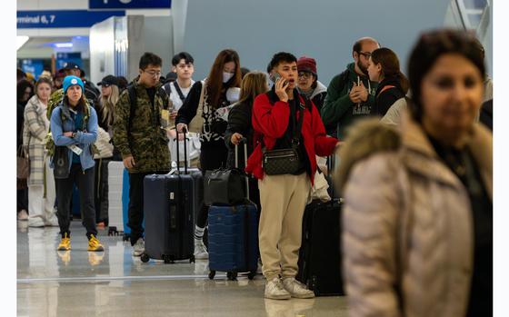 Holiday travelers line up at Los Angeles International Airport on Dec. 21, 2023 in Los Angeles, Calif.