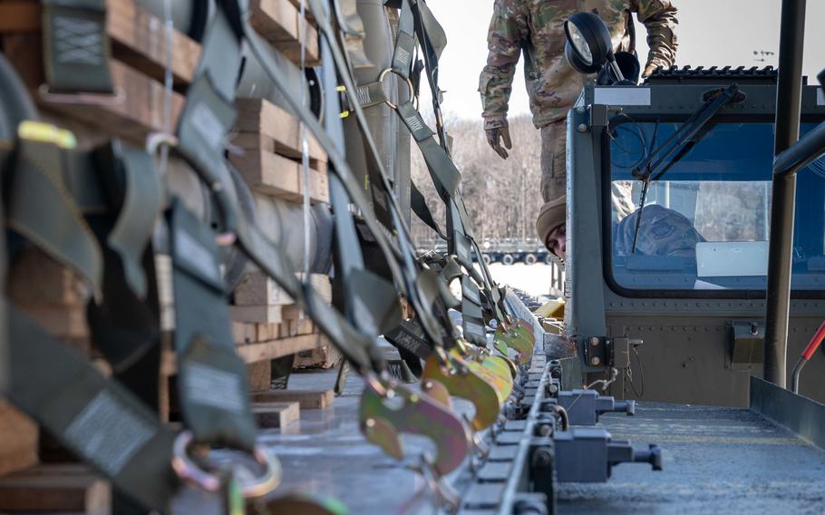 Senior Airman Cody Taylor, 436th Aerial Port Squadron ramp operation specialist, loads cargo during a security assistance mission at Dover Air Force Base, Del., Feb. 3, 2023. 