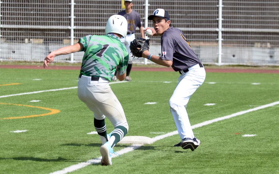 American School In Japan's Ray Takizawa readies a relay throw to first base after erasing Kubasaki's Asher Romnek at second. The Mustangs won 5-4 in nine innings.