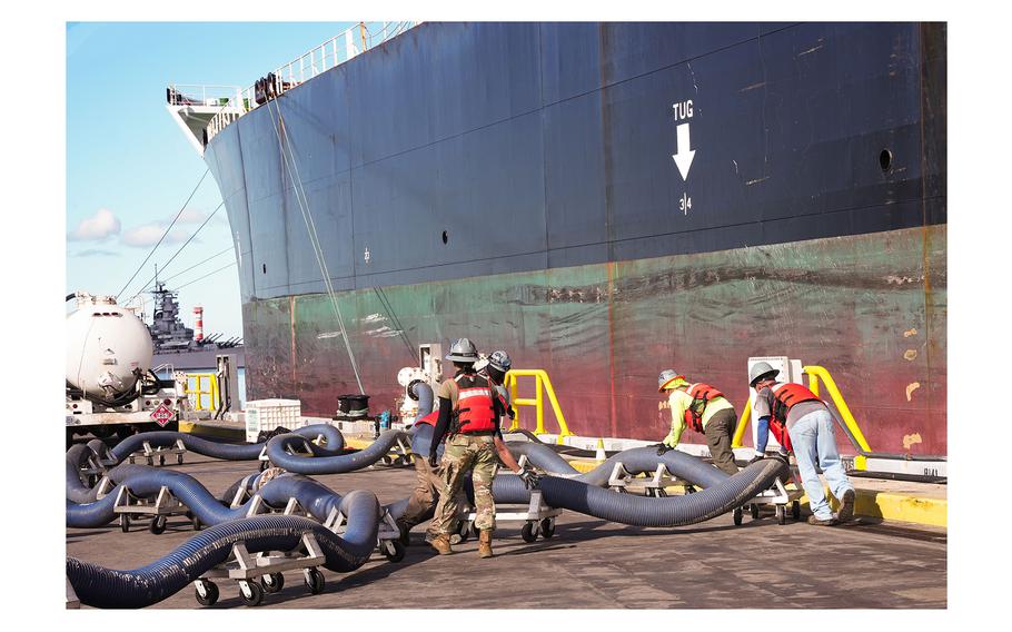 Personnel in support of Joint Task Force-Red Hill prepare fuel lines to be connected to merchant tanker Empire State, initiating the fourth transfer of fuel from the Red Hill Bulk Fuel Storage on Oct. 30, 2023, at Joint Base Pearl Harbor-Hickam, Hawaii. 
